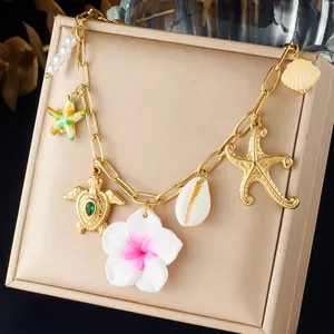 Gold-plated stainless steel charm bracelet with starfish, turtle, and flower pendants.