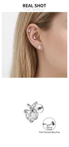 Detail shot of sweet apple heart titanium internal screw cartilage piercing earring
