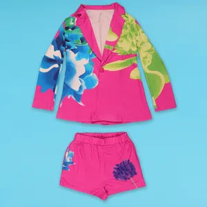 Detail shot of the vibrant pink floral print blazer and matching shorts suit set