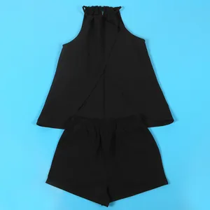 Two-piece black solid color halter top and shorts set displayed on a blue background