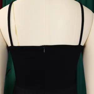 Close-up view showing the hidden back zipper and thin shoulder straps of a black jumpsuit