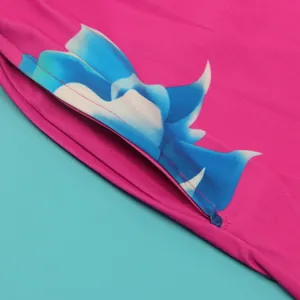 Detailed macro view of vibrant pink garment fabric featuring a stylish blue flame print pattern