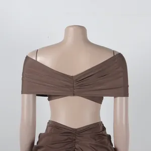 Back view detail of brown off-the-shoulder pleated crop top and matching skirt set