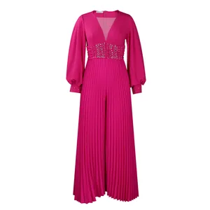 Detailed view of a fuchsia pleated wide-leg jumpsuit featuring beaded waist design