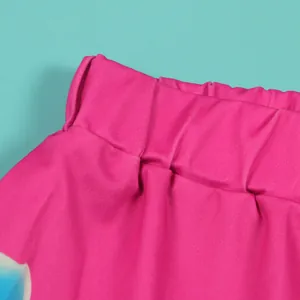 Detailed shot of the elastic waistband on vibrant pink printed shorts with smooth texture
