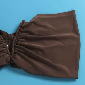 Detailed macro view showing the brown ruched elastic fabric of a sexy sleeveless tube top