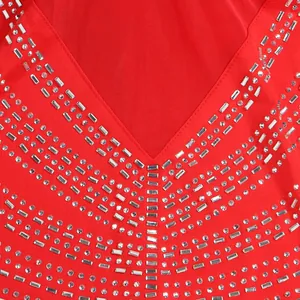 Primer plano de vestido rojo de fiesta con escote en V de malla y detalles de pedrería.