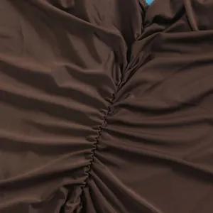 Detail shot of elegant brown ruched stretchy fabric for a sexy floor-length dress