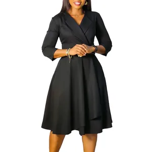 Close-up detail of a classic V-neck black flare dress featuring a high waist design