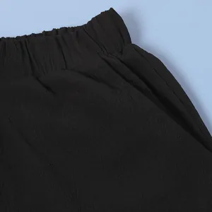 Close-up of the black elastic waistband and side pocket detailing on sleeveless set