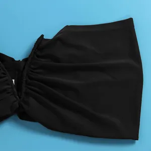 Close-up of black elastic ruched fabric detail for a sexy two-piece skirt set.