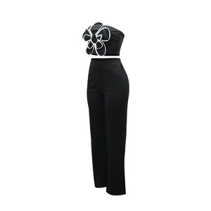 Tenue deux pièces noire élégante avec haut bustier à fleurs et pantalon large taille haute