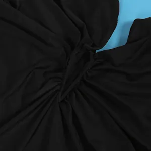 Macro detail showing high-quality black ruched stretchy fabric for floor-length dress