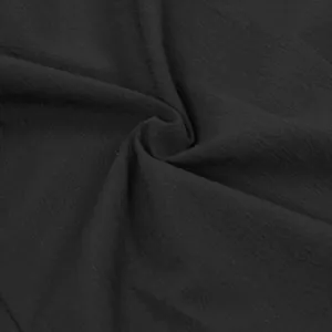 Macro view of the black textured fabric detailing its soft draping and fine weave.