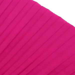 High-definition macro detail of the vibrant magenta pleated fabric texture for jumpsuit
