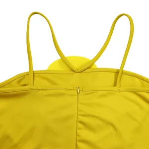 Close-up showing the thin straps and invisible zipper on a yellow pleated jumpsuit back