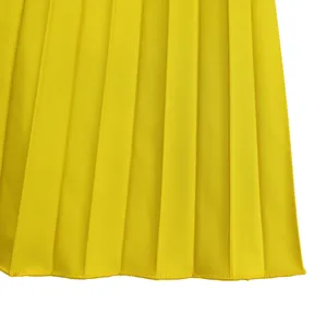 Detailed macro view of vibrant yellow pleated fabric texture for women's jumpsuit