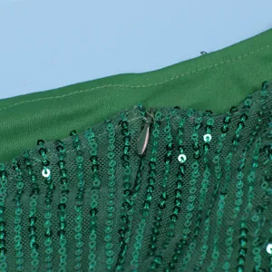 Detailed close-up showing green sequins and high-quality invisible zipper on mesh dress