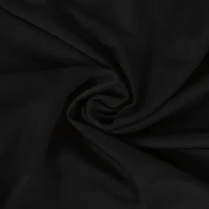 Close-up of black elastic ribbed fabric with elegant pleated texture for maxi dress