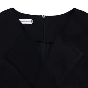 Detailed close-up of a black V-neck fashion dress featuring a back zipper and size tag