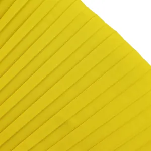 Detailed close-up of bright yellow pleated fabric showing fine accordion texture detail