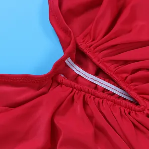 Detail view showing high-quality stitching and elastic band on red pleated dress
