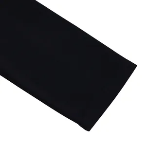 Detailed macro view showing the high-quality stitching on a black fashion dress hemline