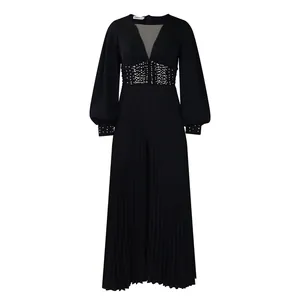 Detail view of elegant black wide-leg jumpsuit with beaded waist and pleated pants