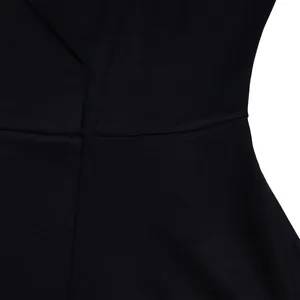 Close-up of black V-neck high waist dress showing fabric texture and flared skirt details.