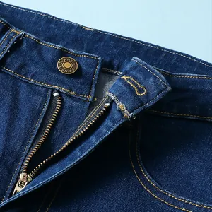 Primo piano del bottone in metallo e della cerniera di questi jeans a zampa in denim elasticizzato.