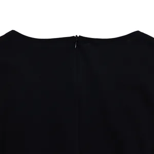 Close-up detail of the back invisible zipper and round neckline on a black jumpsuit