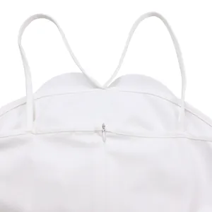 Close-up detail of white jumpsuit showing thin straps and back invisible zipper
