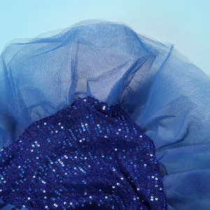 Detailed close-up showing the royal blue sequined fabric and mesh stitching of the dress