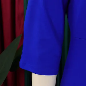 Detailopname van de koningsblauwe getextureerde mouw van een stijlvolle jurk.