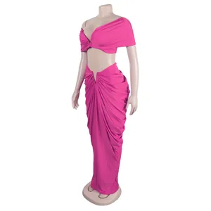 Detail of vibrant pink two-piece set featuring a strapless top and ruched maxi skirt
