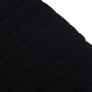 Macro detail showing the fine texture of black pleated fabric for a fashion jumpsuit