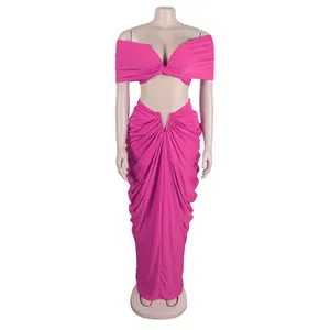 Sexy hot pink two-piece set featuring off-shoulder crop top and draped floor-length skirt