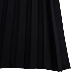 Macro detail shot showing the elegant black pleated fabric of the wide-leg jumpsuit.