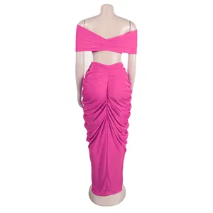 Back view of pink two-piece set featuring off-shoulder top and ruched maxi skirt.