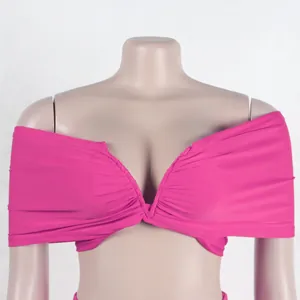 Detailed macro view of the ruched pink off-shoulder elastic top from a two-piece set