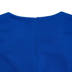 Close-up of invisible zipper on a vibrant blue solid color dress with fine fabric texture.