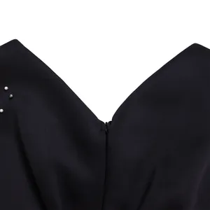 Close-up of V-neckline and invisible zipper on black beaded evening banquet dress