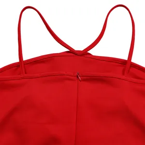Detailed view of red jumpsuit back with thin criss-cross straps and invisible zipper