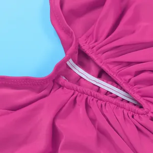 Close-up detail of elastic stitching and soft pleated fabric texture on fuchsia skirt