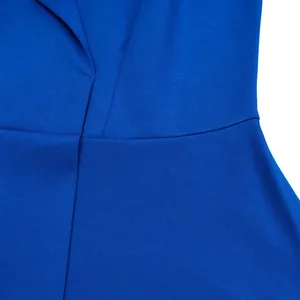 Close-up of blue fabric texture and stitching on a high-waisted V-neck dress.
