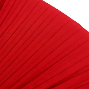 Close-up macro shot showing the fine texture and detail of red pleated fabric