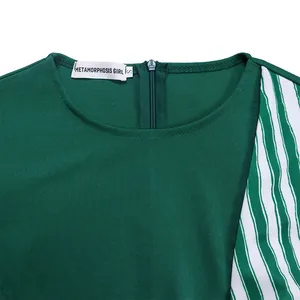 Détail de la robe verte grande taille avec fermeture éclair et rayures