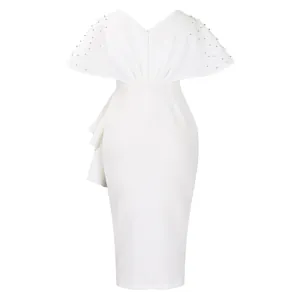 Detailed back view of white evening dress with beaded cape sleeves and ruffles.