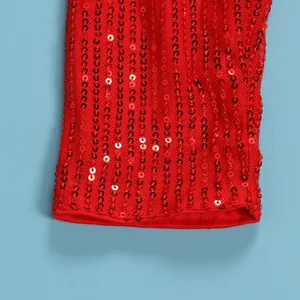 Macro detail of red sequined mesh fabric showing shimmering vertical rows of sequins.