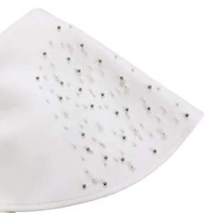 Macro detail of elegant white pearls and silver metal beads on luxury evening dress